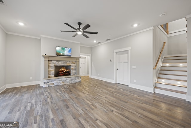 unfurnished living room featuring a fireplace, ceiling fan, wood-type flooring, and ornamental molding