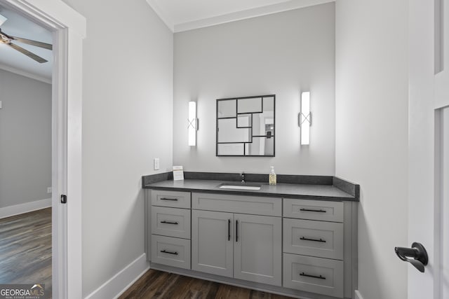 bathroom featuring ceiling fan, vanity, hardwood / wood-style flooring, and crown molding