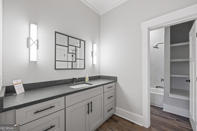 bathroom with bathing tub / shower combination, vanity, crown molding, and hardwood / wood-style floors