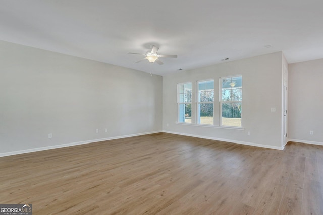 empty room featuring light hardwood / wood-style flooring and ceiling fan