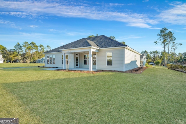 view of front of home with a patio area and a front lawn