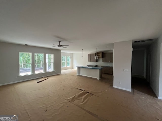 unfurnished living room with ceiling fan