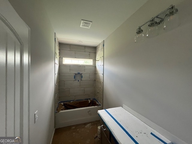 bathroom featuring vanity and a tub to relax in