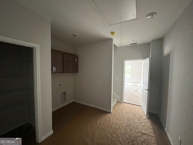 clothes washing area featuring carpet and cabinets