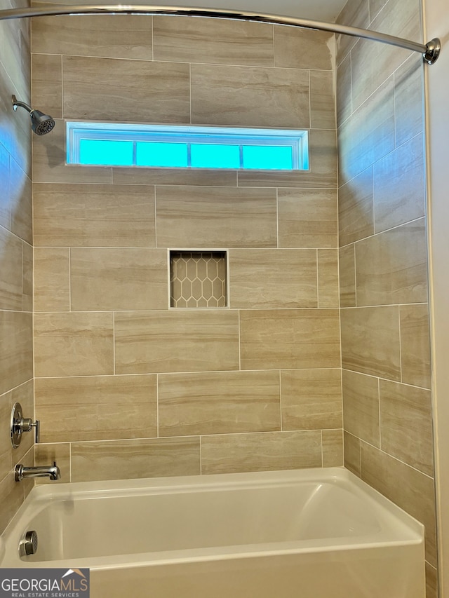 bathroom featuring tiled shower / bath combo and plenty of natural light