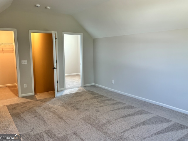 additional living space with lofted ceiling and light colored carpet