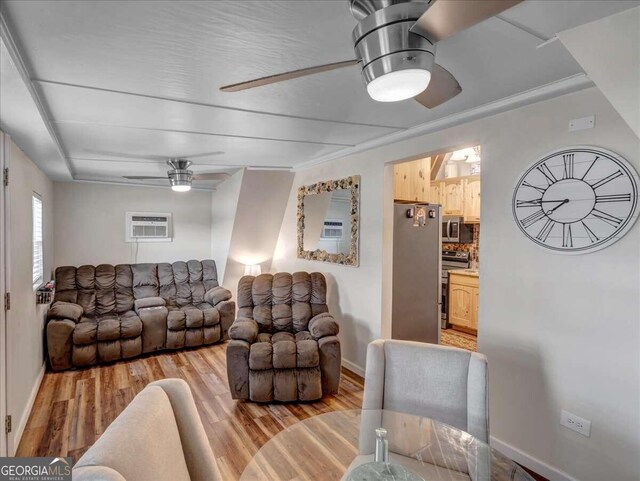 living room with ceiling fan, a wall mounted AC, and wood-type flooring