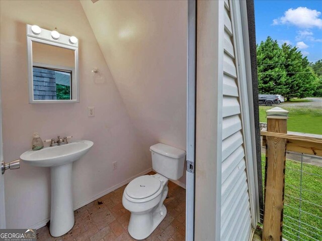 bathroom featuring sink, toilet, and tile floors