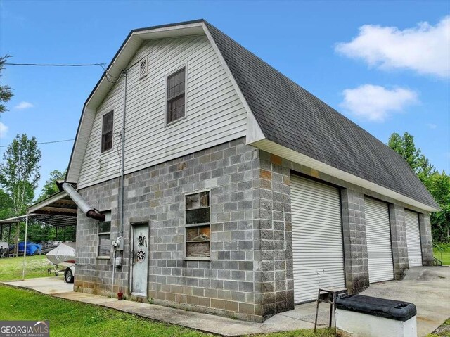 view of home's exterior with an outdoor structure and a garage