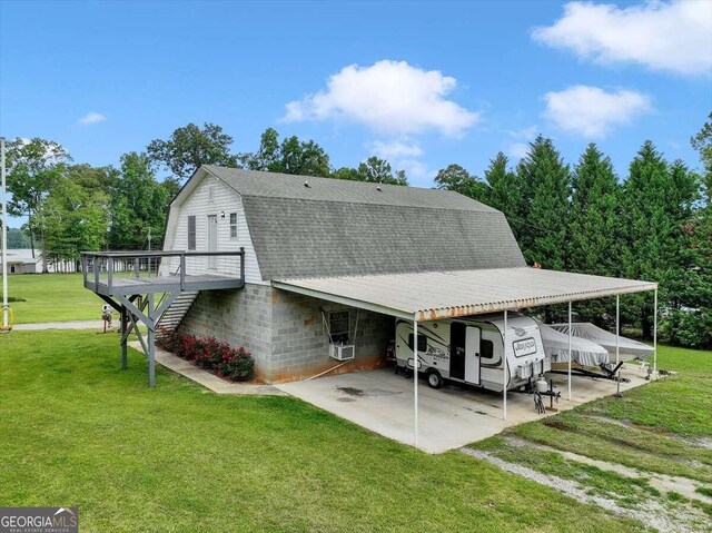 rear view of property featuring a carport and a yard