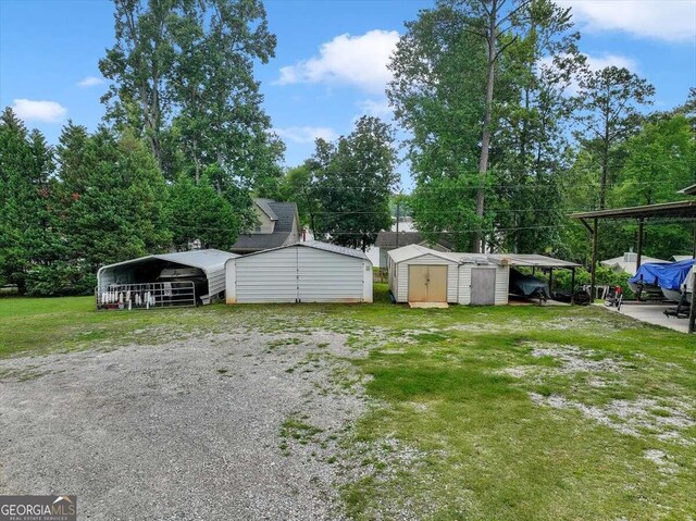 view of yard with a carport and a shed