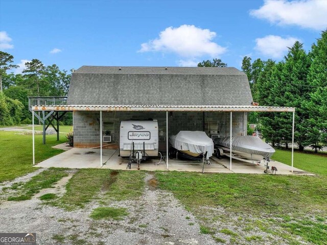 back of house with a lawn and a patio