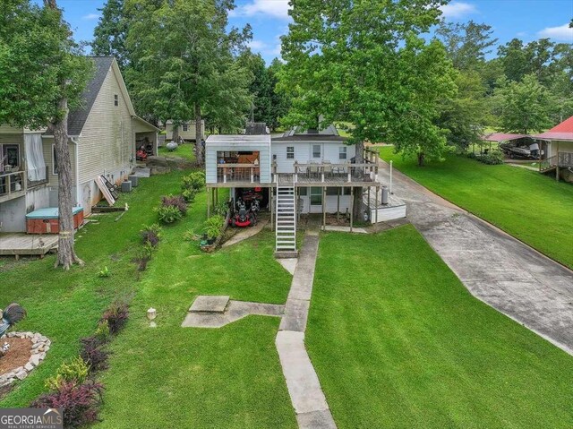 view of front of property with a wooden deck and a front lawn