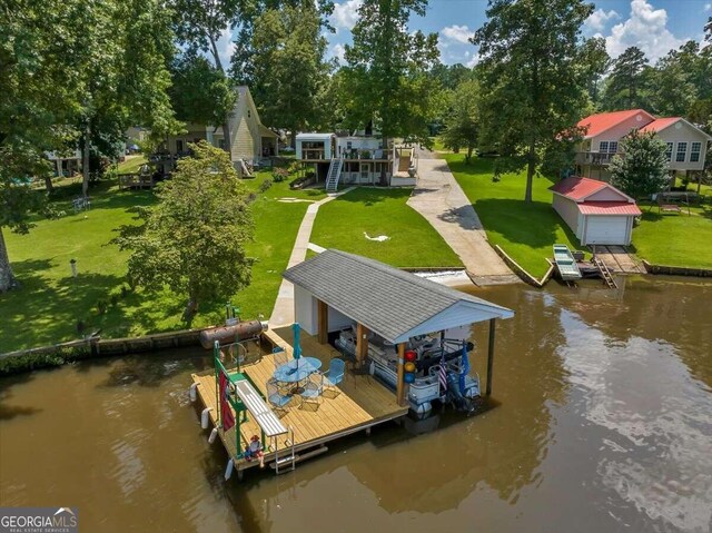 view of dock featuring a water view and a yard