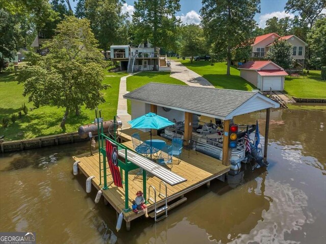 view of dock with a water view and a yard