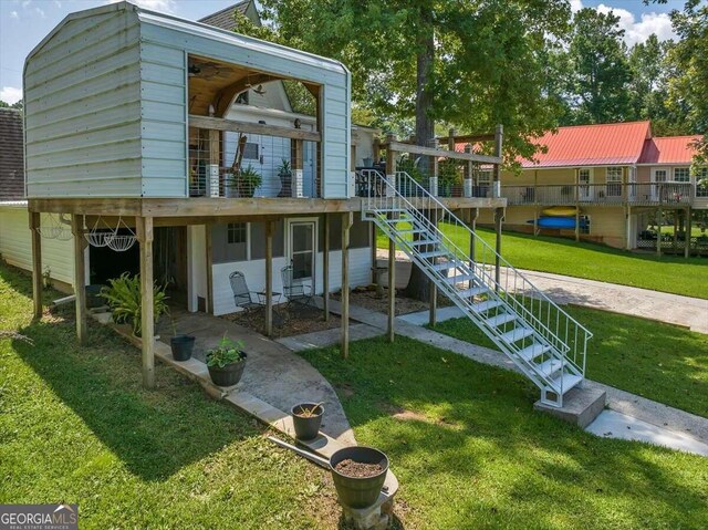 back of house featuring a deck and a yard