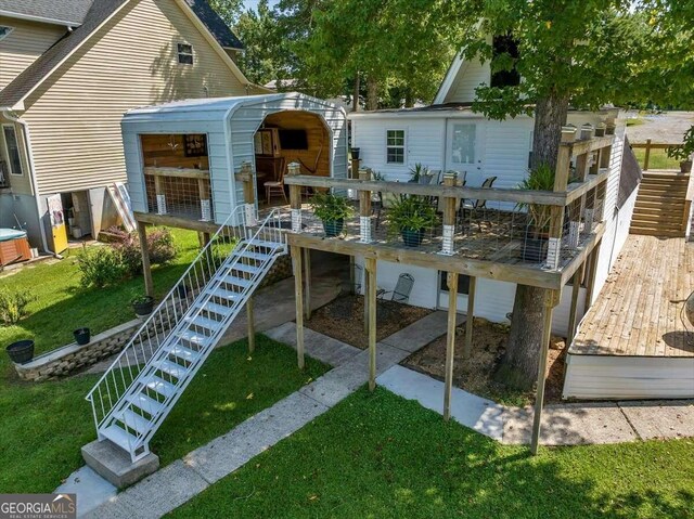 rear view of house with a deck and a lawn