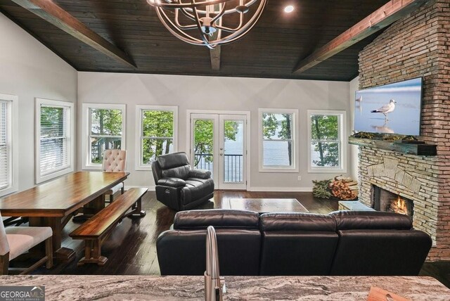 living room featuring dark hardwood / wood-style floors, beamed ceiling, a chandelier, and wooden ceiling