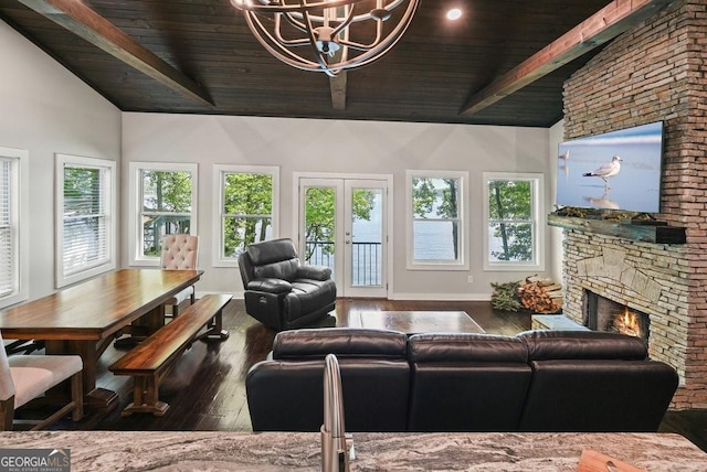 living room with french doors, vaulted ceiling with beams, a fireplace, wood-type flooring, and an inviting chandelier