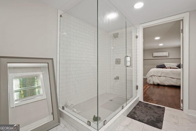 full bathroom featuring ensuite bathroom, baseboards, marble finish floor, a stall shower, and a wall mounted air conditioner