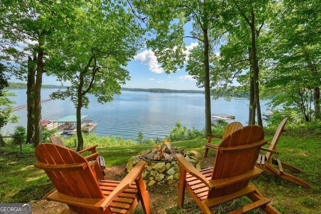 view of patio / terrace with a water view and an outdoor fire pit