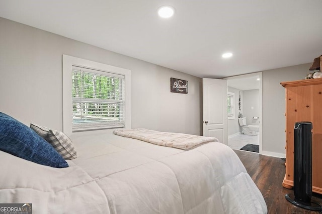 bedroom with connected bathroom, recessed lighting, dark wood finished floors, and baseboards