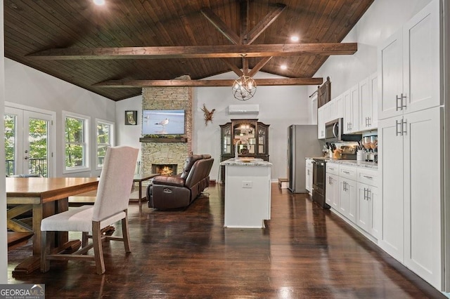 dining space featuring dark wood-style floors, wood ceiling, a fireplace, and beamed ceiling