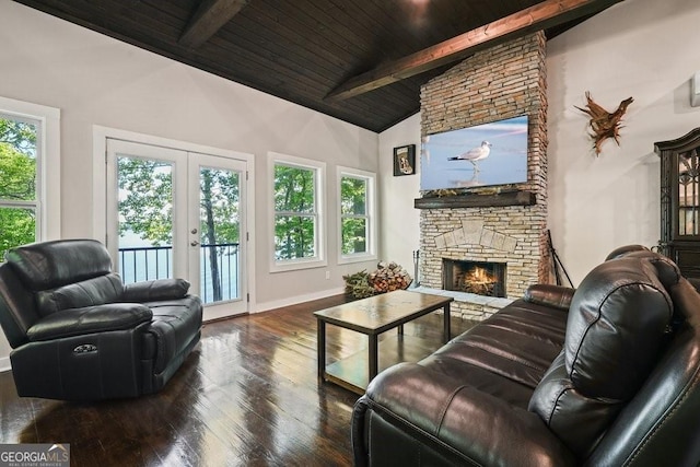 living room with beamed ceiling, a stone fireplace, dark hardwood / wood-style floors, and wood ceiling