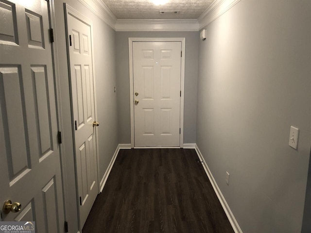 doorway featuring a textured ceiling, dark hardwood / wood-style floors, and ornamental molding