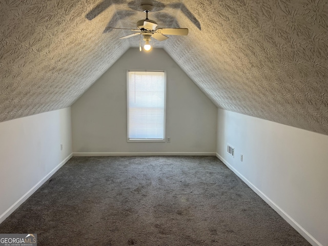 bonus room featuring carpet, a textured ceiling, ceiling fan, and lofted ceiling