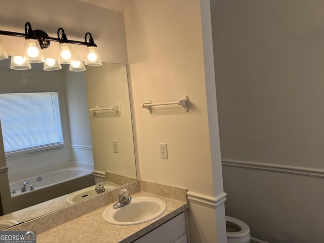 bathroom featuring vanity, toilet, and a bathing tub