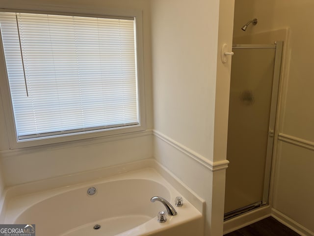 bathroom with separate shower and tub