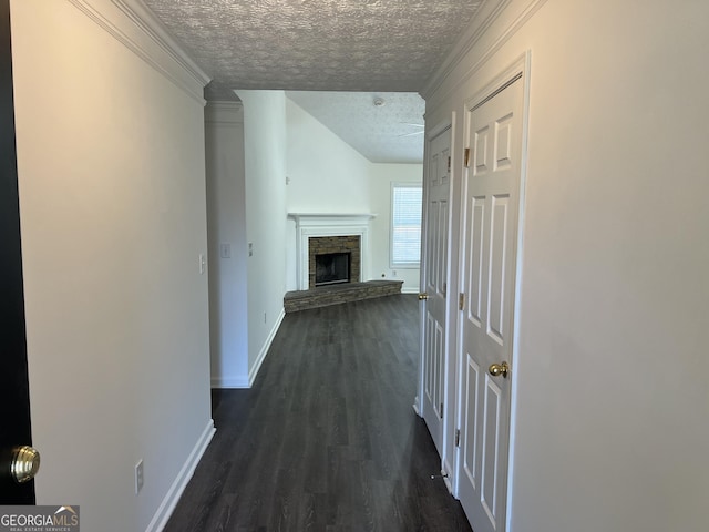 hallway with crown molding, dark hardwood / wood-style flooring, and a textured ceiling