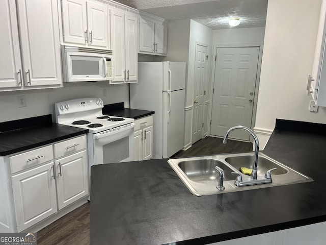 kitchen with white appliances, white cabinets, sink, a textured ceiling, and dark hardwood / wood-style flooring