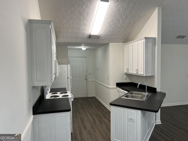 kitchen with white appliances, dark wood-type flooring, white cabinets, sink, and kitchen peninsula