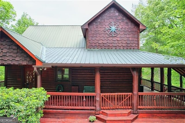 rear view of house with a wooden deck