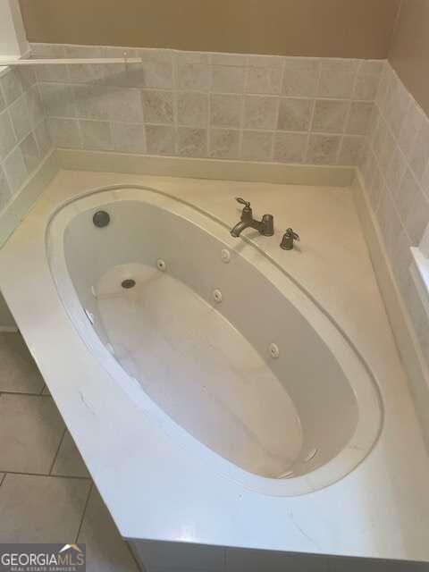 interior details featuring tile flooring and a bathing tub