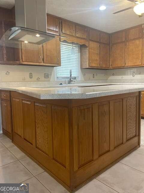 kitchen featuring fume extractor, sink, ceiling fan, and light tile floors