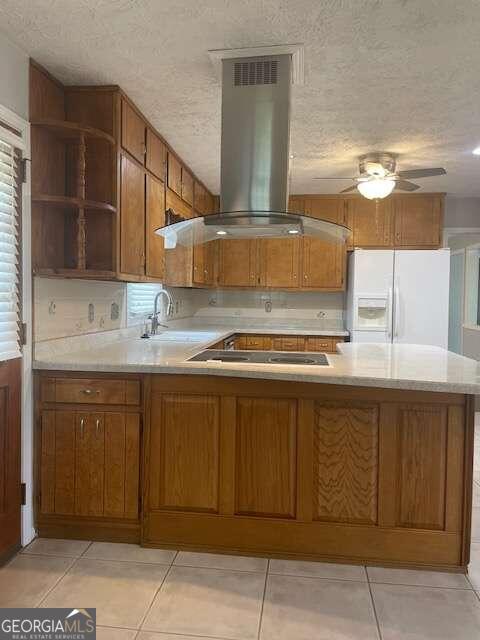 kitchen with kitchen peninsula, black electric cooktop, island exhaust hood, ceiling fan, and white refrigerator with ice dispenser