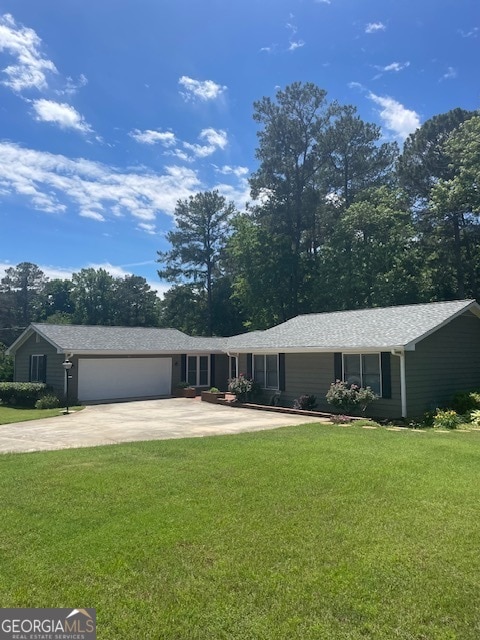 single story home with a garage and a front yard