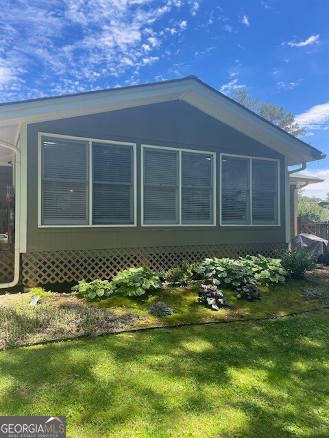 view of home's exterior with a lawn