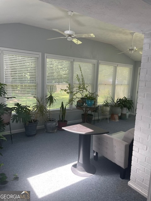 unfurnished sunroom with lofted ceiling and ceiling fan