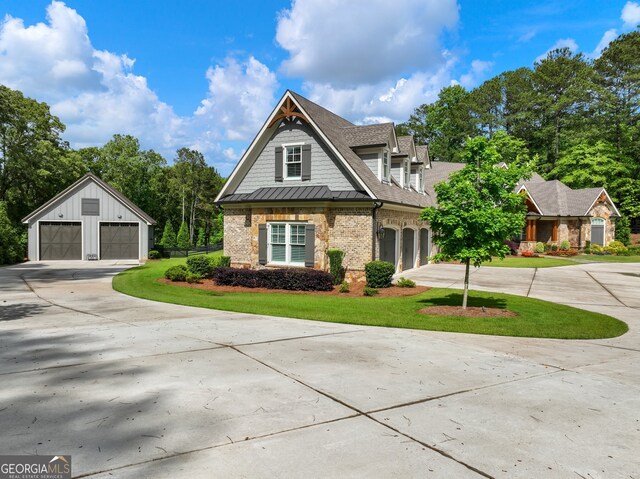 view of front of home featuring a garage and an outdoor structure