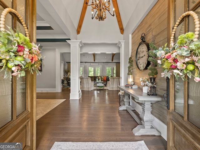 entrance foyer featuring ornate columns, lofted ceiling with beams, and dark hardwood / wood-style floors