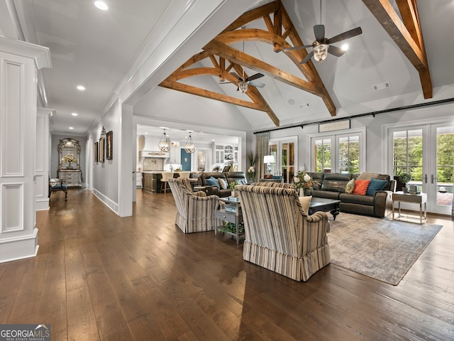 living room featuring ceiling fan, dark hardwood / wood-style flooring, and beam ceiling