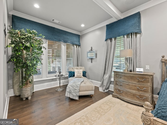 sitting room with beamed ceiling, ornamental molding, and dark wood-type flooring