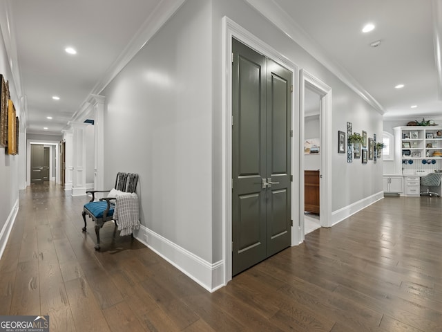 corridor featuring ornamental molding and dark hardwood / wood-style flooring