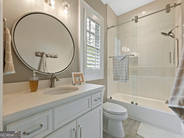 full bathroom featuring tiled shower / bath, vanity, toilet, and tile floors