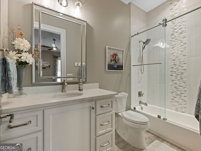 full bathroom featuring toilet, ceiling fan, tile flooring, tiled shower / bath, and vanity