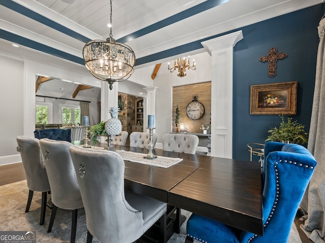 dining space with beam ceiling, hardwood / wood-style floors, a chandelier, and ornate columns